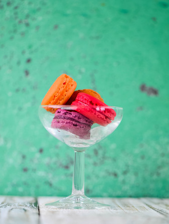 Colorful macarons on vintage pastel background. Macaron or Macaroon sweet meringue-based confection.の写真素材