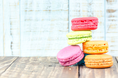 Colorful macarons on vintage pastel background. Macaron or Macaroon sweet meringue-based confection.の写真素材