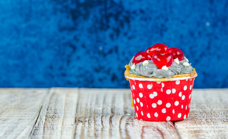 Colorful cupcakes on a wooden backgroundの写真素材