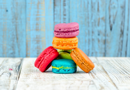 Colorful macarons on vintage pastel background. Macaron or Macaroon sweet meringue-based confection.の写真素材