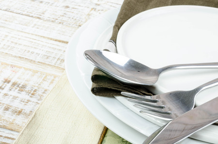 Blank plate with fork and knife on tablecloth backgroundの写真素材