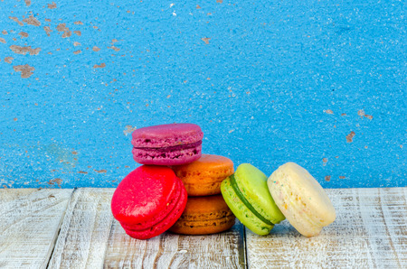 Colorful macarons on vintage pastel background. Macaron or Macaroon sweet meringue-based confection.の写真素材