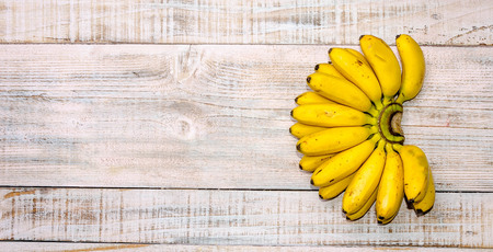Fresh bananas on wooden backgroundの写真素材