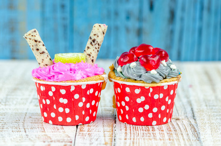 Colorful cupcakes on a wooden backgroundの写真素材