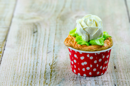Colorful cupcakes on a wooden backgroundの写真素材