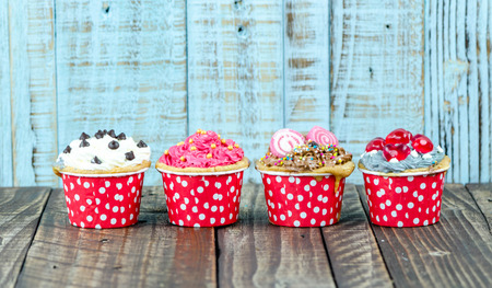Colorful cupcakes on a wooden backgroundの写真素材