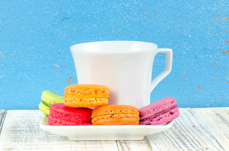 Colorful macarons on vintage pastel background. Macaron or Macaroon sweet meringue-based confection.の写真素材