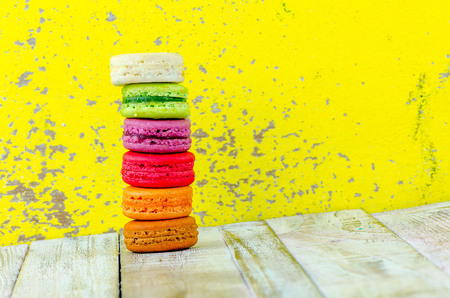 Colorful macarons on vintage pastel background. Macaron or Macaroon sweet meringue-based confection.の写真素材