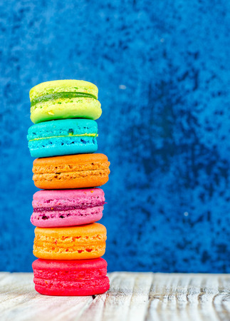 Colorful macarons on vintage pastel background. Macaron or Macaroon sweet meringue-based confection.の写真素材