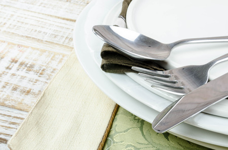 Blank plate with fork and knife on tablecloth backgroundの写真素材