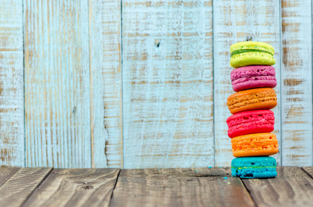 Colorful macarons on vintage pastel background. Macaron or Macaroon sweet meringue-based confection.の写真素材