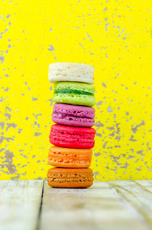Colorful macarons on vintage pastel background. Macaron or Macaroon sweet meringue-based confection.の写真素材