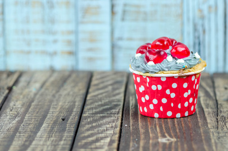 Colorful cupcakes on a wooden backgroundの写真素材