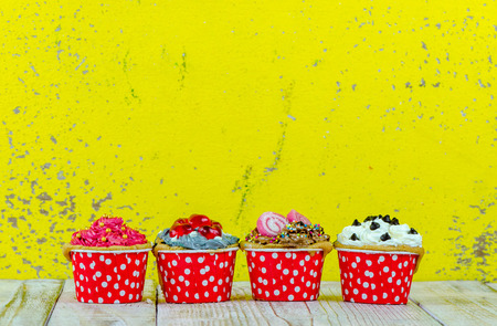 Colorful cupcakes on a wooden backgroundの写真素材