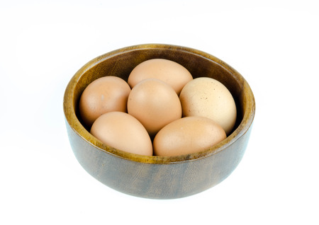 Eggs in basket on white backgroundの写真素材