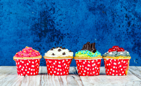 Colorful cupcakes on a wooden backgroundの写真素材