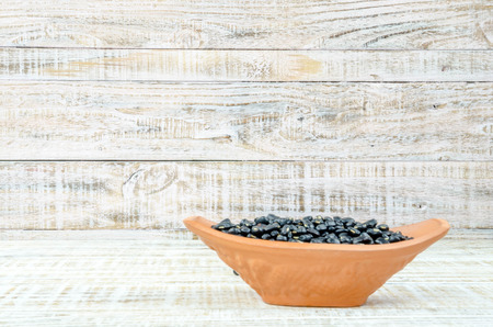 Black beans on a wooden background.の写真素材