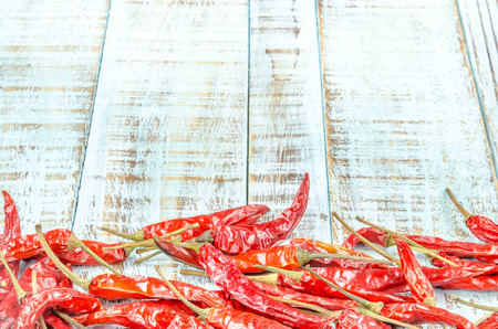 Red hot chili peppers on old wooden tableの写真素材