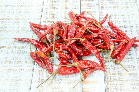 Red hot chili peppers on old wooden table