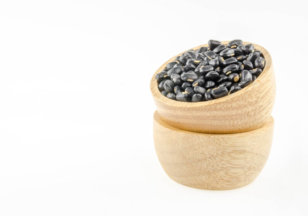 Black beans in a cup on a white background.