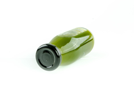 Kiwi juice in a bottle on a white background.の写真素材