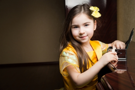 Girl in a yellow dress with a yellow bow  Hand in boxの写真素材