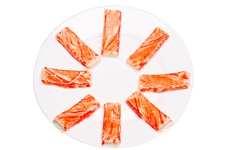 Crab sticks on a white plate. Isolated white backgroundの写真素材