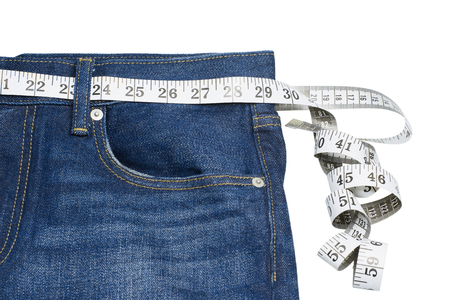 Measuring tape on blue jeansの写真素材