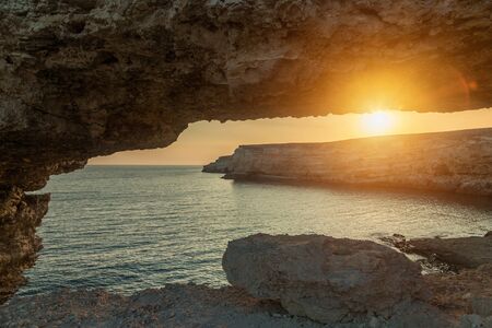 Sunset on the sea among the rocky mountainsの写真素材