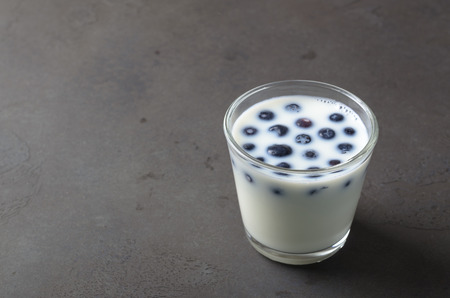 Full glass of milk with blueberries, copy space for your textの写真素材