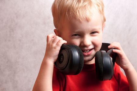 smiling little boy with headphonesの写真素材