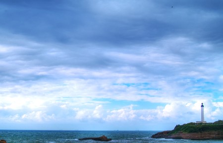 beautiful ocean, lihthouse on cliffの写真素材