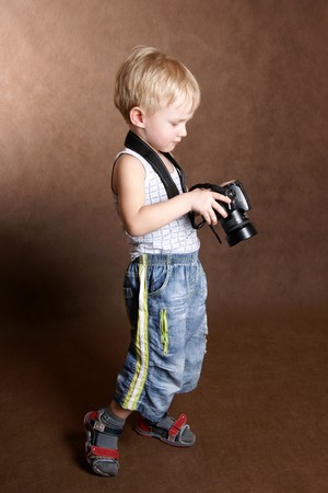 child in studio with professional cameraの写真素材