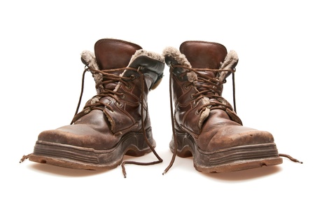 old brown boots isolated on whiteの写真素材
