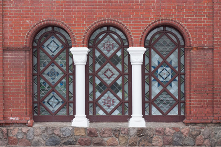 Brick wall with decoration, arches, window openings and two columns の写真素材