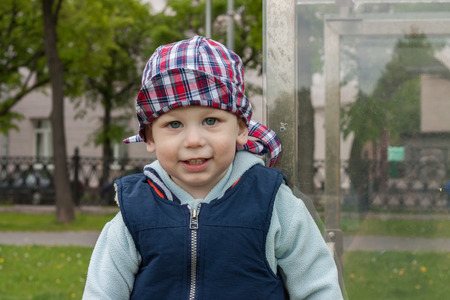 joyful glad happy one and a half year old child in city parkの写真素材