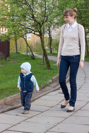 Mother and son walk in the city parkの写真素材