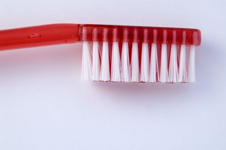 close-up of red toothbrush against white backgroundの写真素材