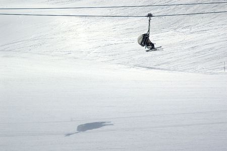 a chairlift transporting skiers to the top of the mountainの写真素材