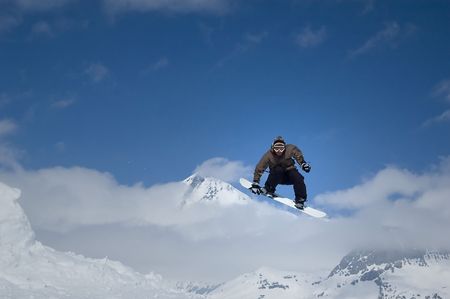 snowboarder jumping high in the air performing a grab
