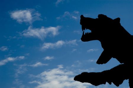 silhouette of a bear against blue cloudy skyの写真素材