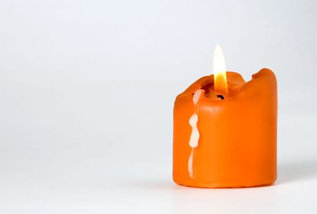 Orange Burning candle isolated on white backgroundの写真素材