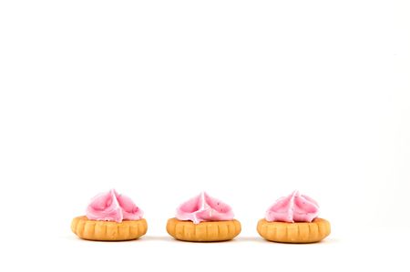 three cookies with pink sugar, isolated on white backgroundの写真素材