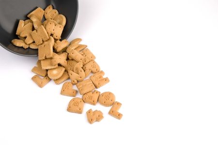 letter cookies out of a bowl isolated on white backgroundの写真素材