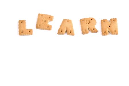 the word LEARN spelled in letter cookies and isolated on white backgroundの写真素材