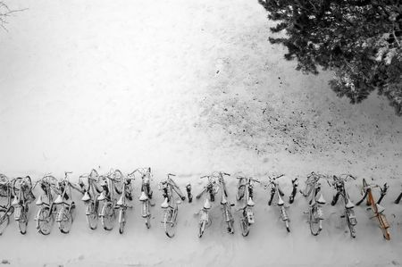 a row of bikes covered in snowの写真素材