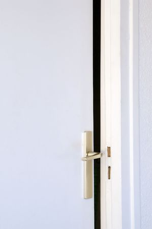 open door set ajar with visible latchの写真素材