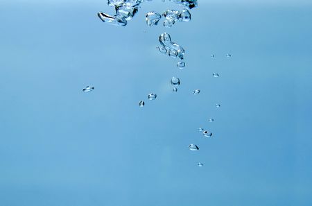 isolated air-bubbles rising in the water, isolated over blue