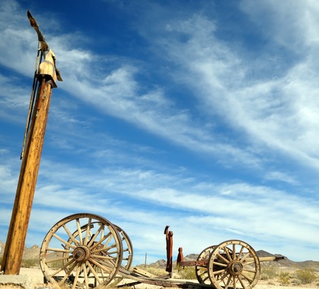 The blue sky and the broken vehicle, all that remains from trailblazers of the wild West in the Valley of death Nevadaの写真素材