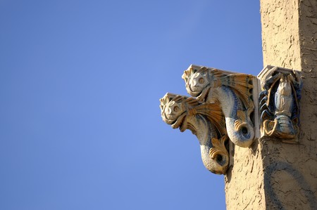 see life figures on the stone walll and ornament on a blue backgroundの写真素材